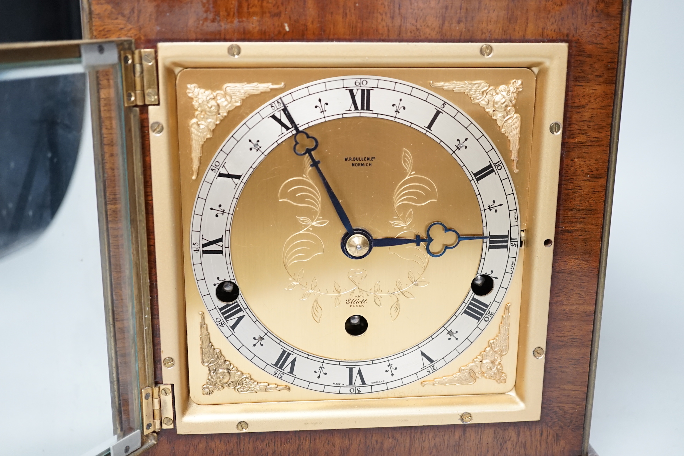 An Elliott walnut mantel clock, traditional dial and chiming movement, 25cm high